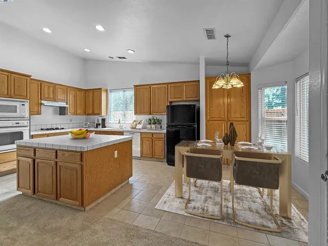 a kitchen with stainless steel appliances granite countertop a stove and a refrigerator