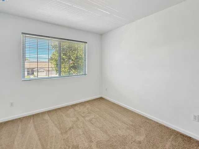a view of a hallway with wooden cabinets