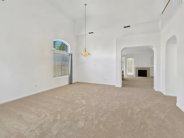 a view of empty room with fireplace