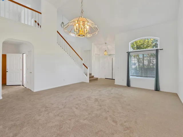 an empty room with windows and entrance