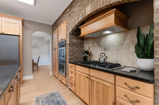 a kitchen with stainless steel appliances a sink and cabinets