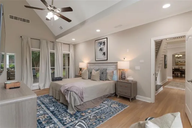 a bedroom with a large bed and a chandelier