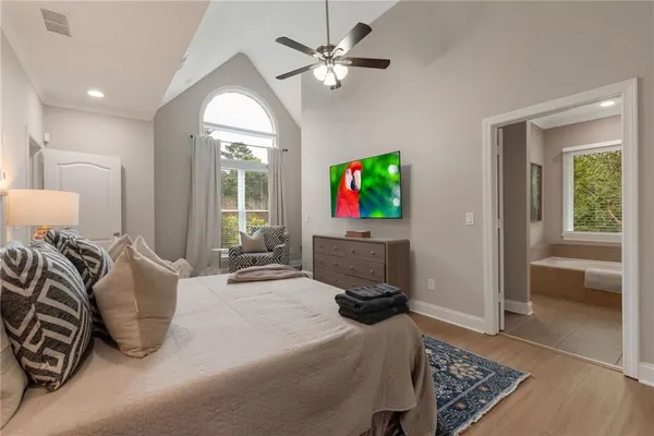 a bedroom with furniture and a flat screen tv