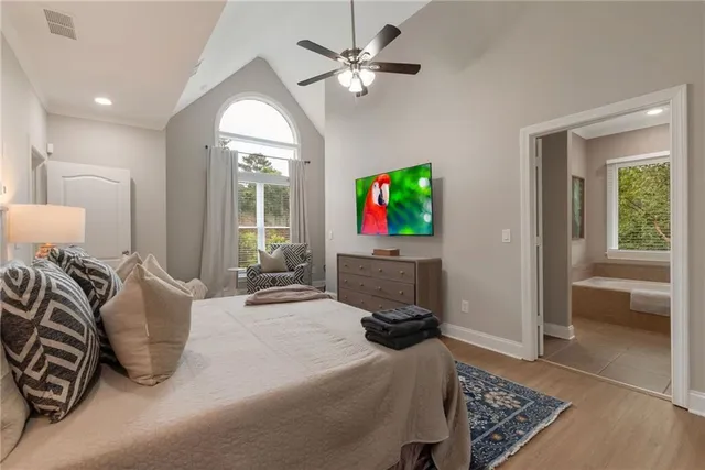 a bedroom with furniture and a flat screen tv