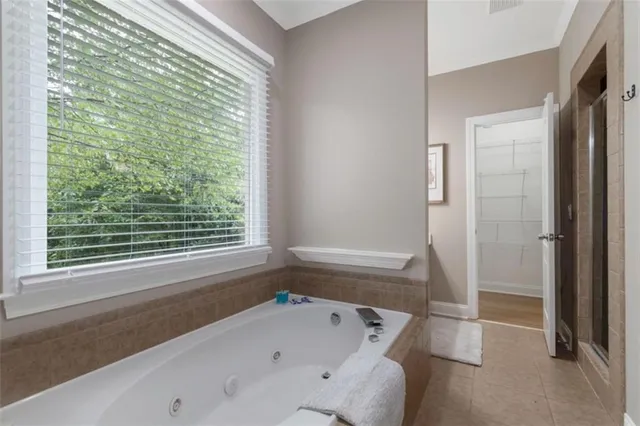 a bathroom with a bathtub and a shower