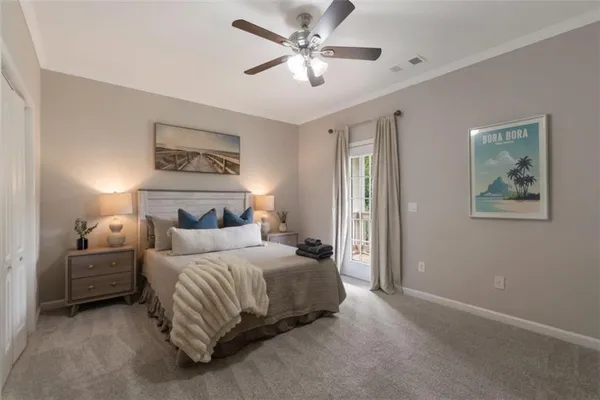 a bedroom with a bed and a painting on the wall