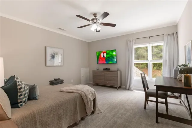 a bedroom with a bed window and a desk