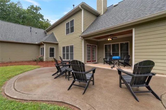 a view of a house with backyard and sitting area