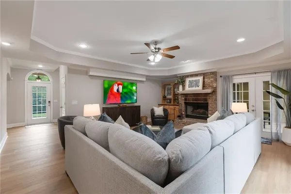 a living room with furniture a fireplace and a flat screen tv