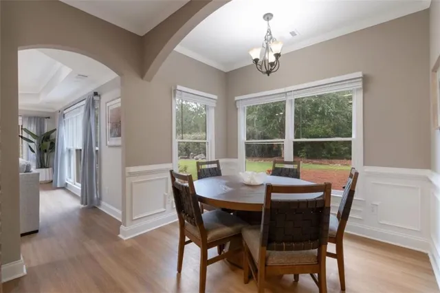 a view of a dining room with furniture window and wooden floor