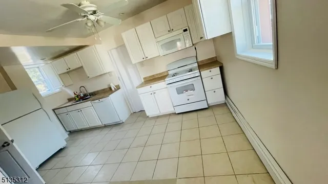 a view of a utility room with cabinets