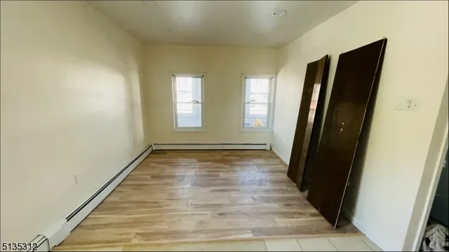 a view of a room with wooden floor and glass windows