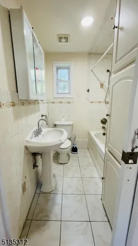 a bathroom with a sink toilet and mirror