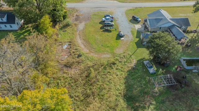 a aerial view of a house with a yard