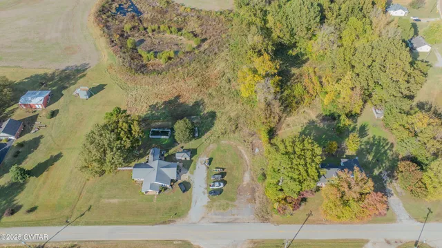 an aerial view of a house with a yard and lake view