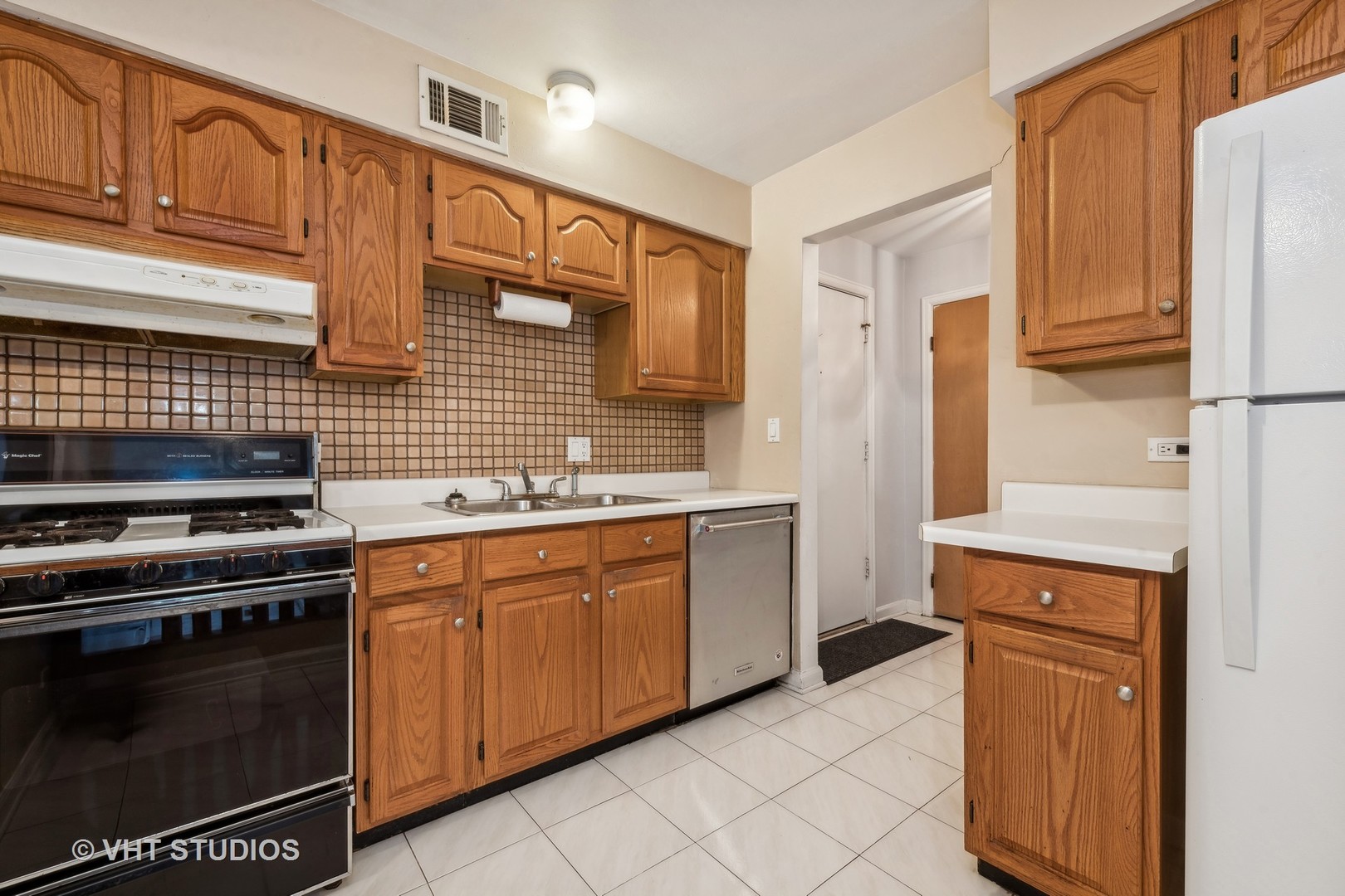 5300 Carriageway Drive, Unit 112 Rolling Meadows, IL 60008 - Photo 5 of 12 a kitchen with granite countertop cabinets and steel stainless steel appliances