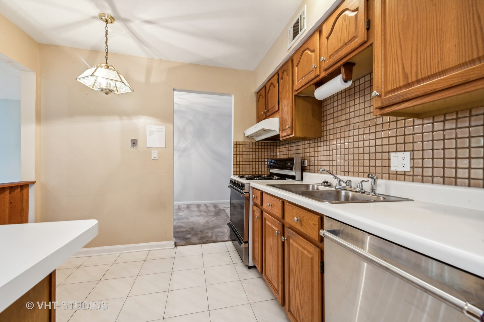 5300 Carriageway Drive, Unit 112 Rolling Meadows, IL 60008 - Photo 6 of 12 a kitchen with stainless steel appliances a sink dishwasher stove refrigerator and cabinets