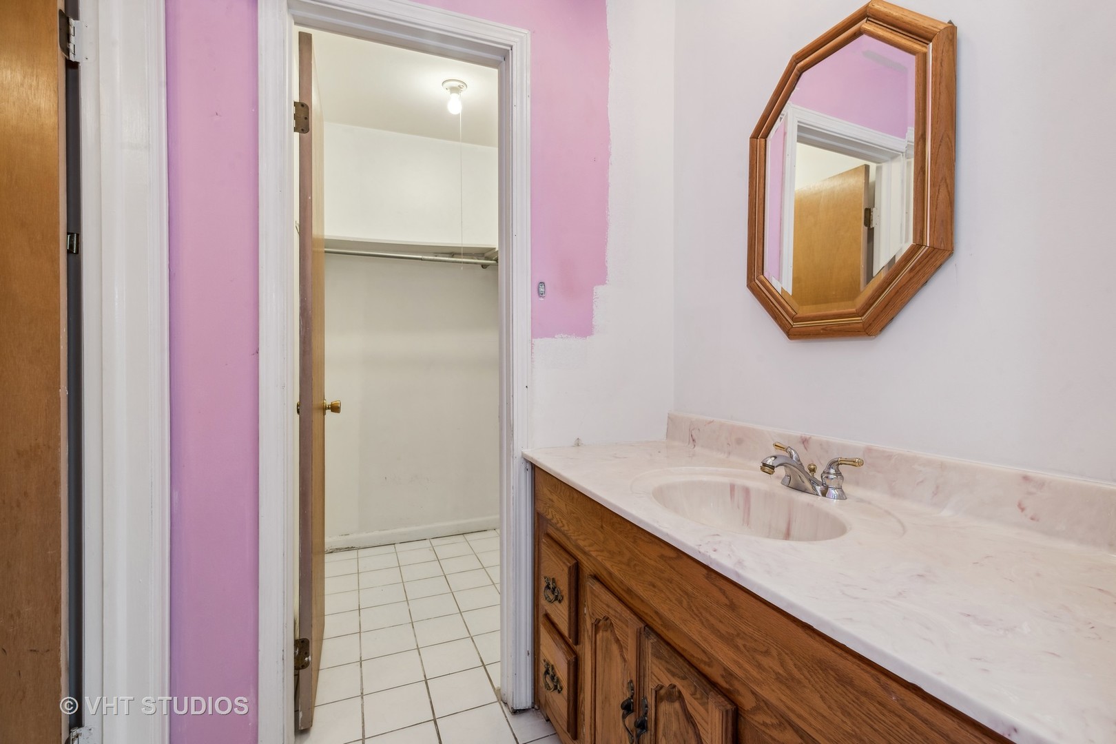 5300 Carriageway Drive, Unit 112 Rolling Meadows, IL 60008 - Photo 8 of 12 a bathroom with a sink a mirror and a vanity
