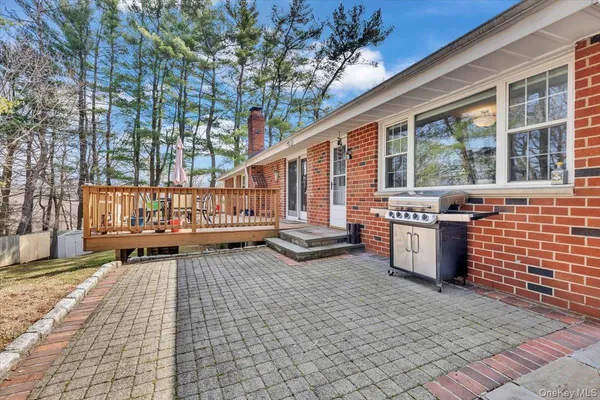 a view of a porch with wooden floor and fence