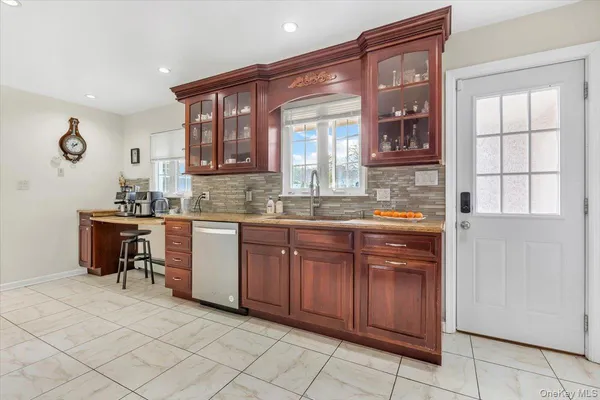 a kitchen with granite countertop a sink and cabinets