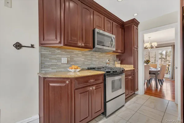 a kitchen with stainless steel appliances granite countertop a stove and a microwave