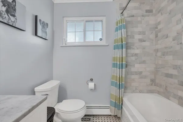 a bathroom with a bathtub and toilet