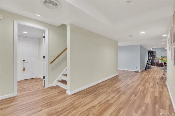 a view of a room with wooden floor and stairs