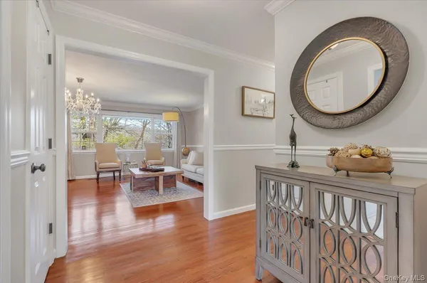 a view of a dining room with furniture a chandelier and wooden floor