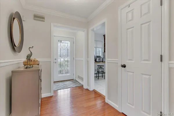 a view of a livingroom with wooden floor and entryway