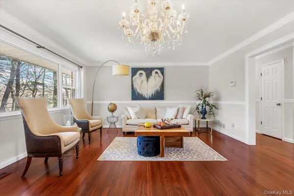 a living room with furniture and a chandelier