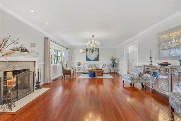 a living room with furniture fireplace and wooden floor
