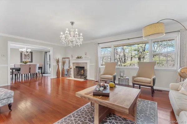 a living room with furniture a fireplace and a large window