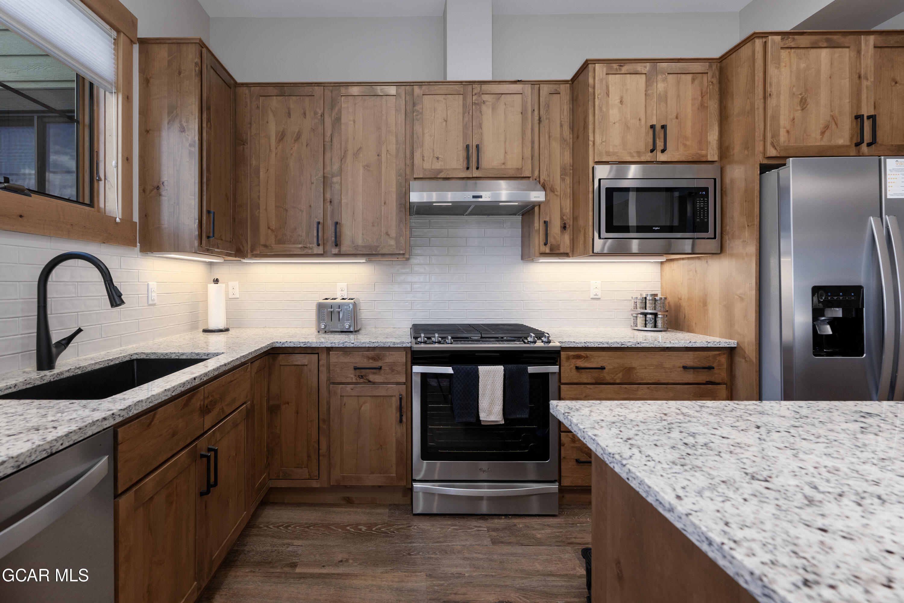 40 Springview Lane Fraser, CO 80442 - Photo 21 of 36 a kitchen with stainless steel appliances granite countertop a sink stove and refrigerator