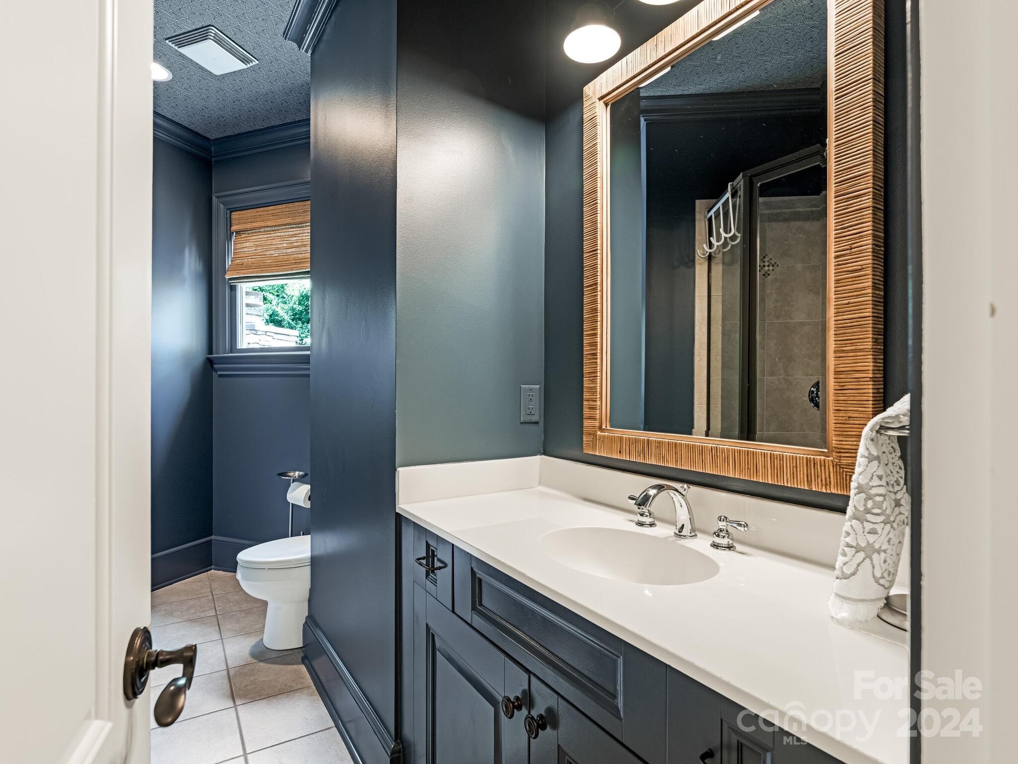 330 South Canterbury Road Charlotte, NC 28211 - Photo 27 of 41 a bathroom with a sink and a mirror