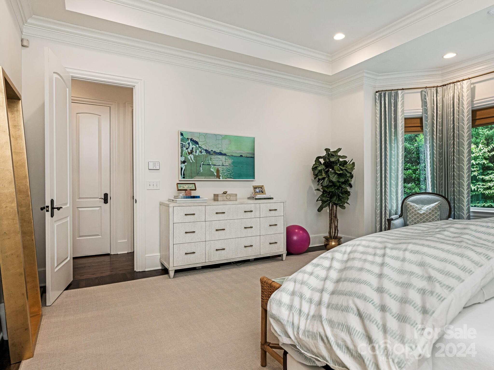 330 South Canterbury Road Charlotte, NC 28211 - Photo 9 of 41 a bedroom with a bed a dresser and a potted plant