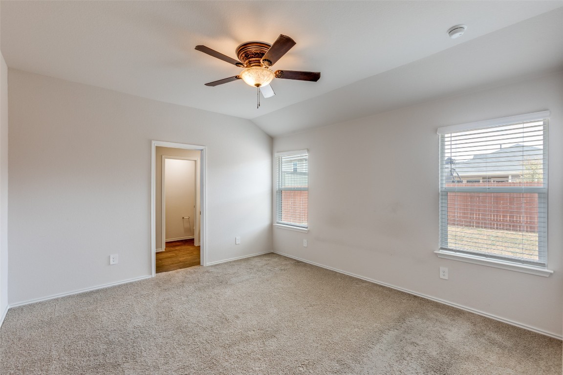 408 Frogmore Loop Kyle, TX 78640 - Photo 11 of 25 an empty room with windows and fan