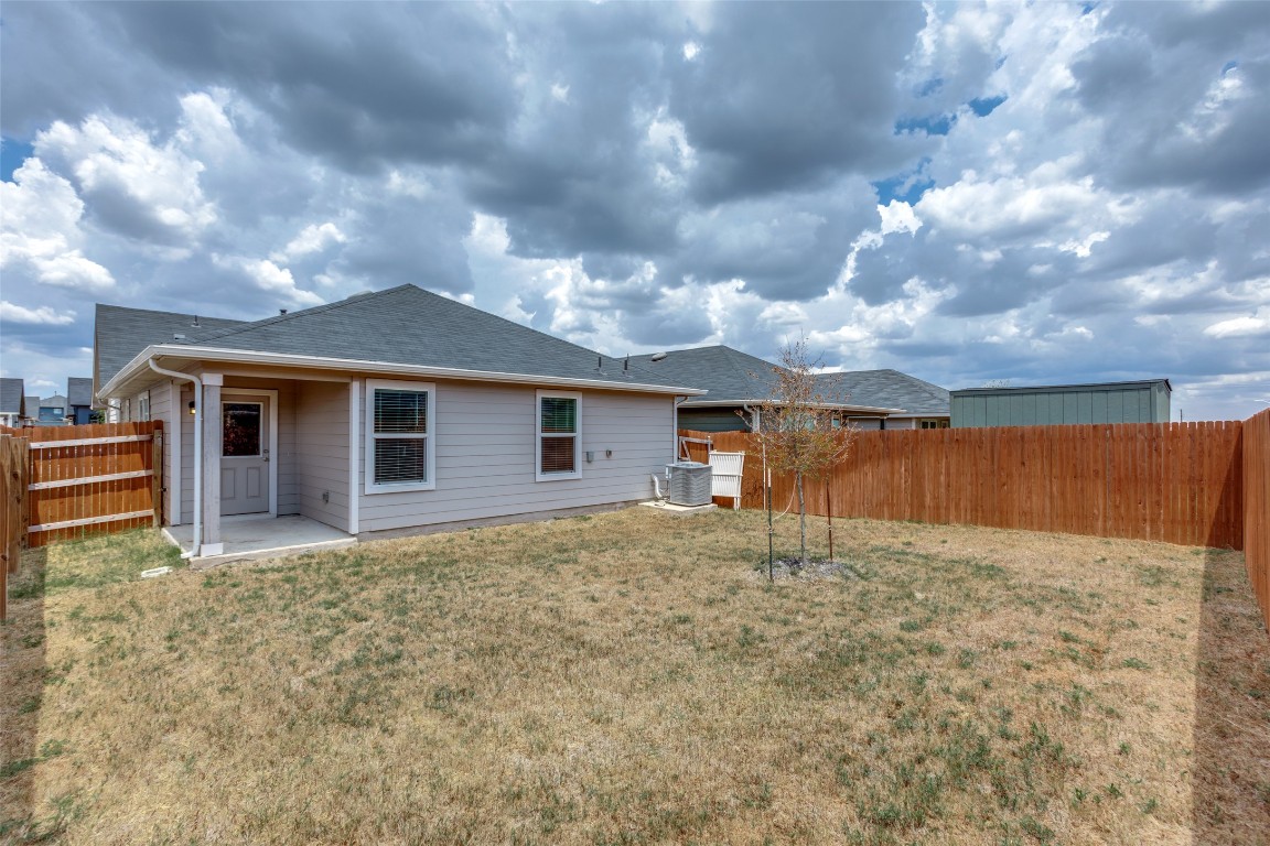 408 Frogmore Loop Kyle, TX 78640 - Photo 21 of 25 a view of a house with a yard
