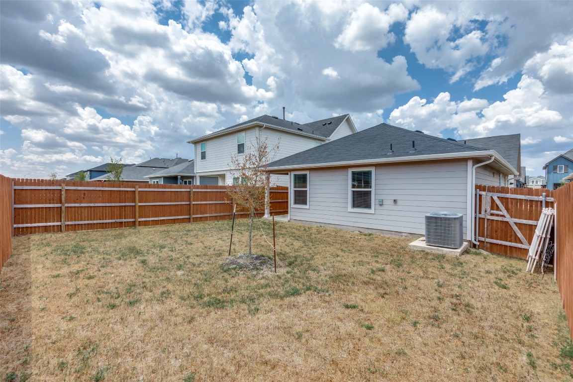 408 Frogmore Loop Kyle, TX 78640 - Photo 23 of 25 a view of a house with a yard