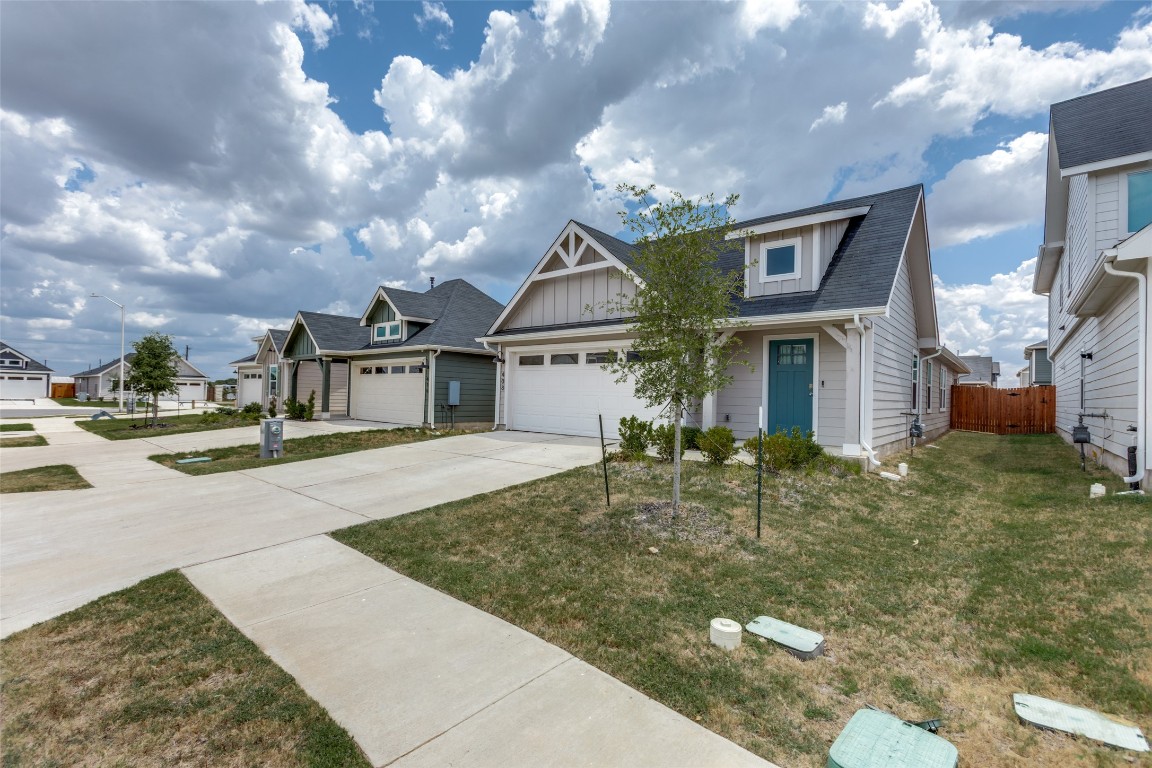 408 Frogmore Loop Kyle, TX 78640 - Photo 3 of 25 a front view of a house with garden
