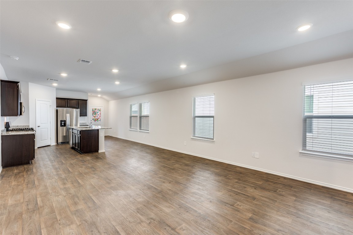 408 Frogmore Loop Kyle, TX 78640 - Photo 25 of 25 a large kitchen with stainless steel appliances a large counter top a stove and a refrigerator