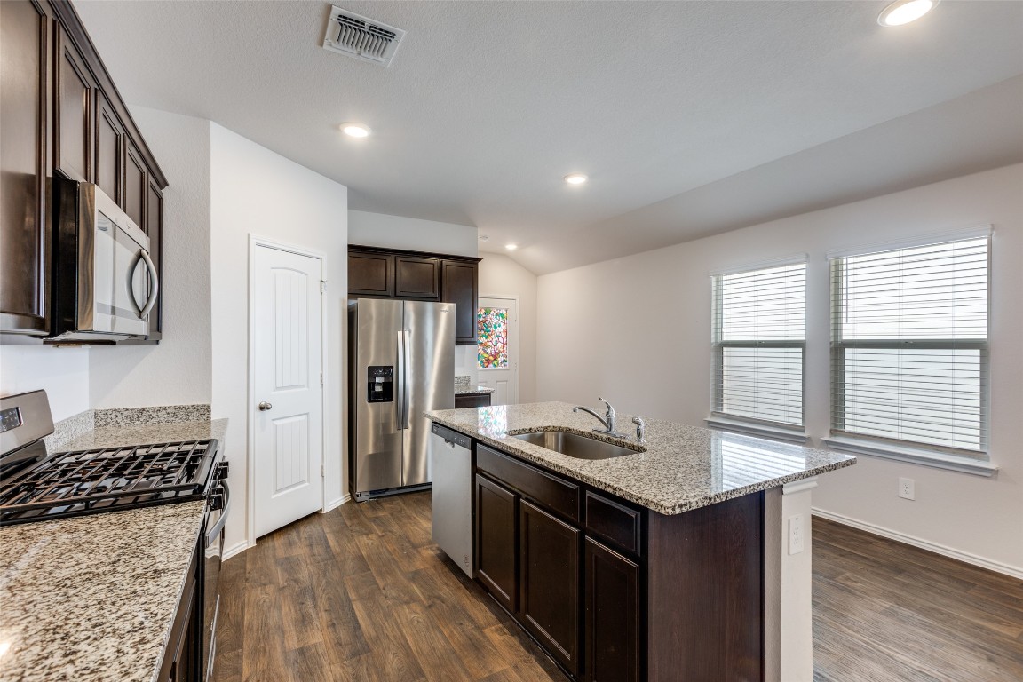 408 Frogmore Loop Kyle, TX 78640 - Photo 8 of 25 a kitchen with a sink stove and refrigerator