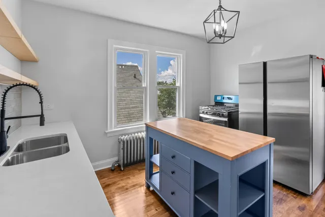 a kitchen with a table chairs and refrigerator