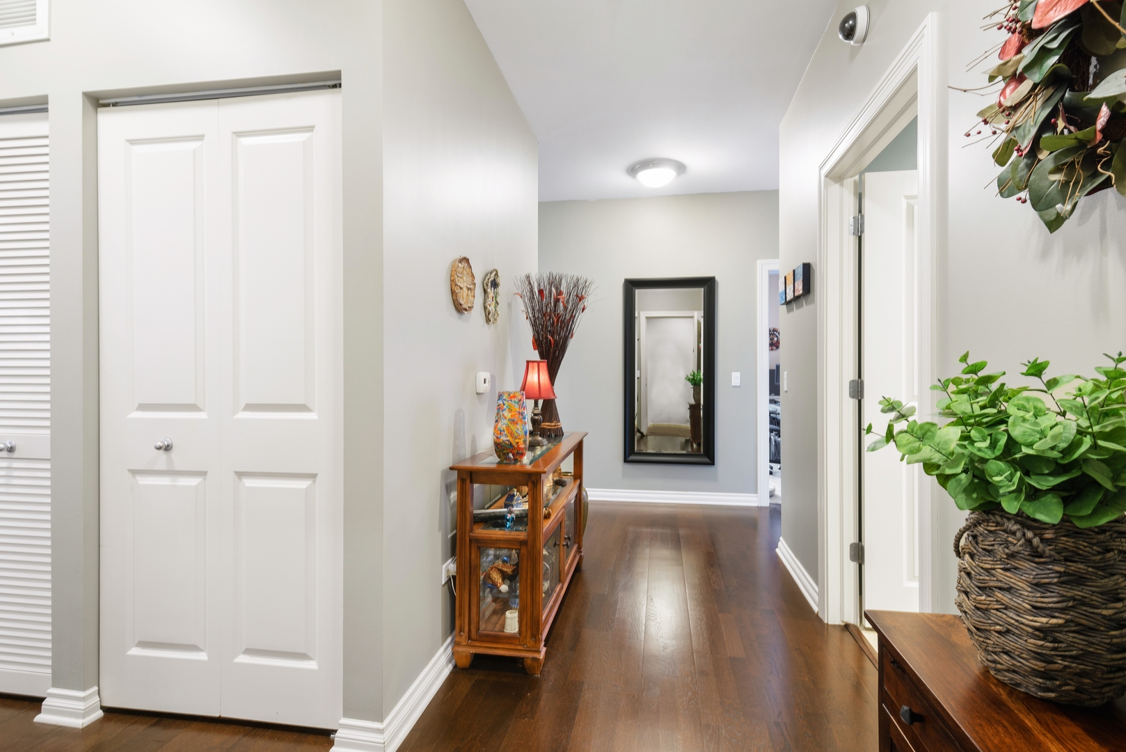5556 North Sheridan Road, Unit 408 Chicago, IL 60640 - Photo 2 of 19 a hallway with wooden floor and stairs
