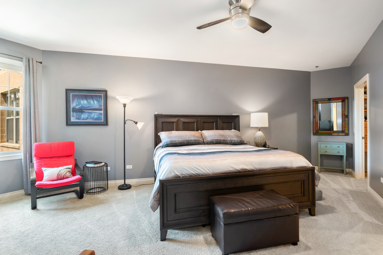 5556 North Sheridan Road, Unit 408 Chicago, IL 60640 - Photo 12 of 19 a bedroom with a bed and a chandelier