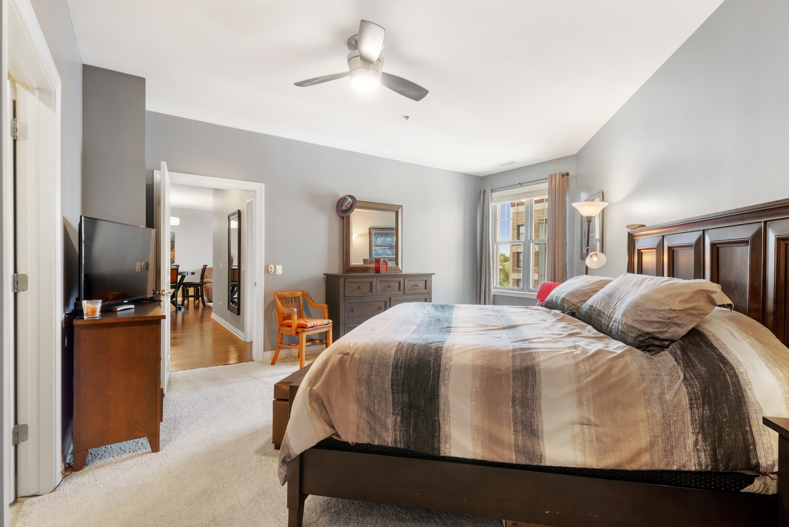 5556 North Sheridan Road, Unit 408 Chicago, IL 60640 - Photo 13 of 19 a bedroom with a bed and a chandelier