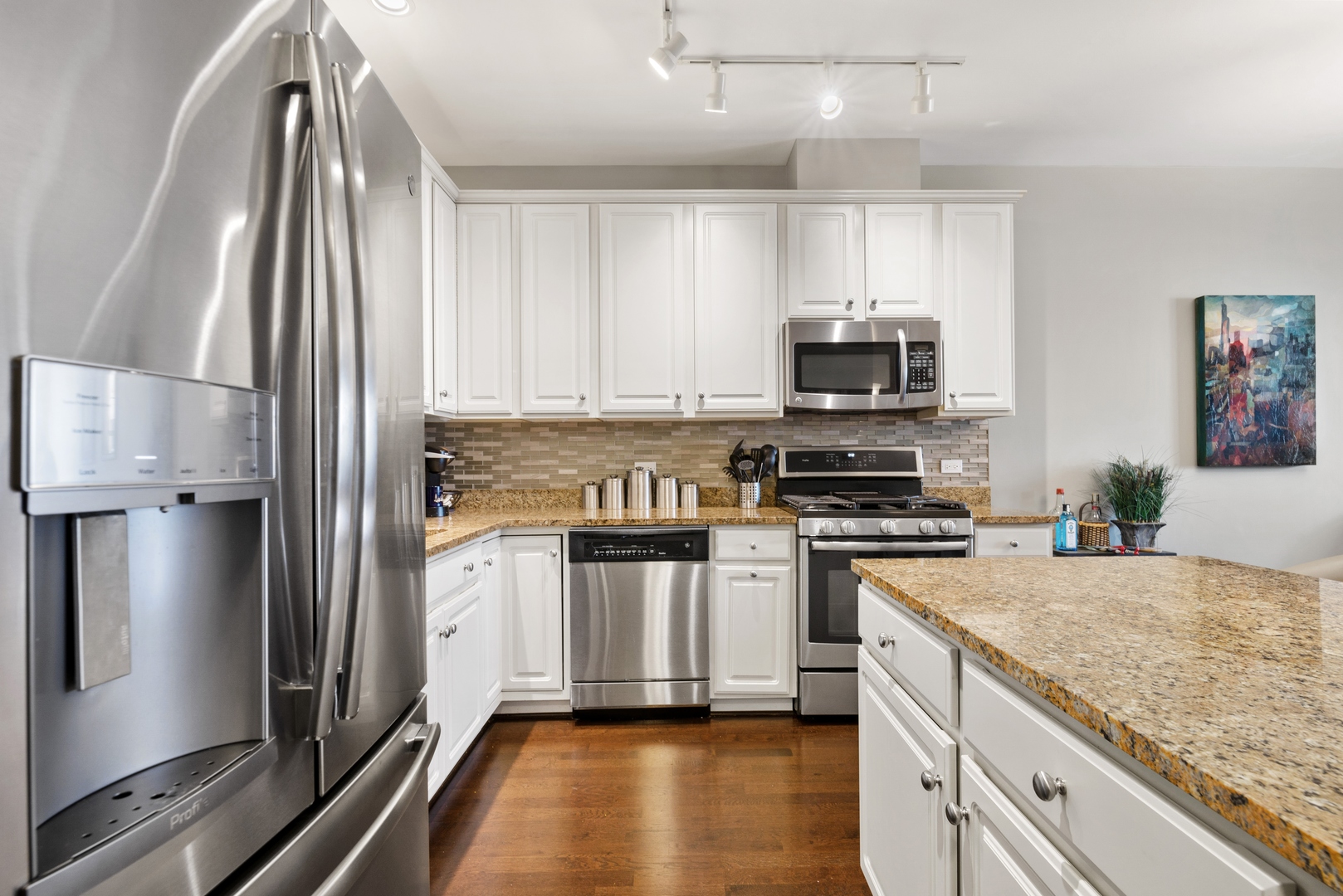 5556 North Sheridan Road, Unit 408 Chicago, IL 60640 - Photo 3 of 19 a kitchen with stainless steel appliances granite countertop a stove a sink and a refrigerator
