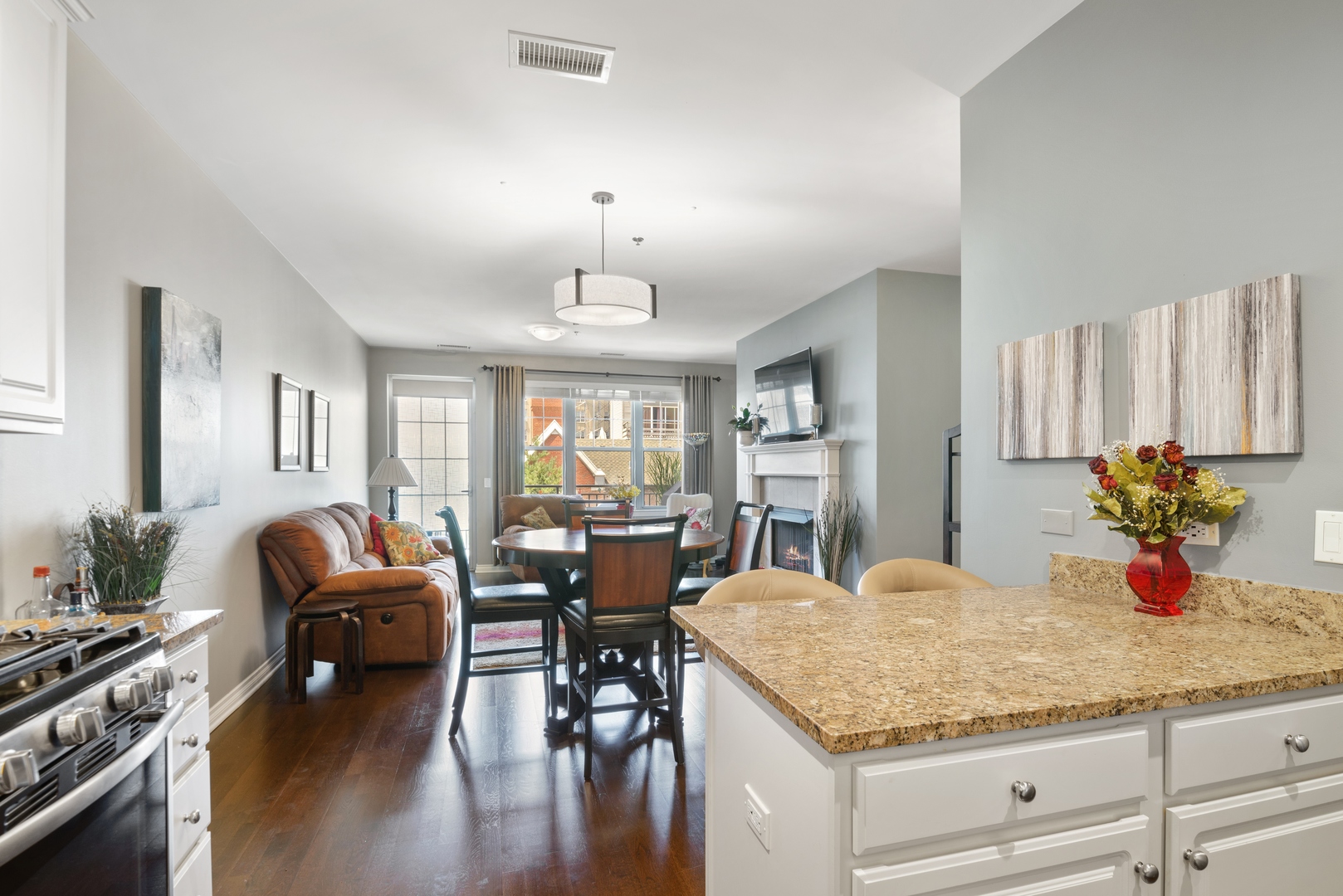 5556 North Sheridan Road, Unit 408 Chicago, IL 60640 - Photo 5 of 19 a view of a dining room and livingroom with furniture wooden floor a chandelier