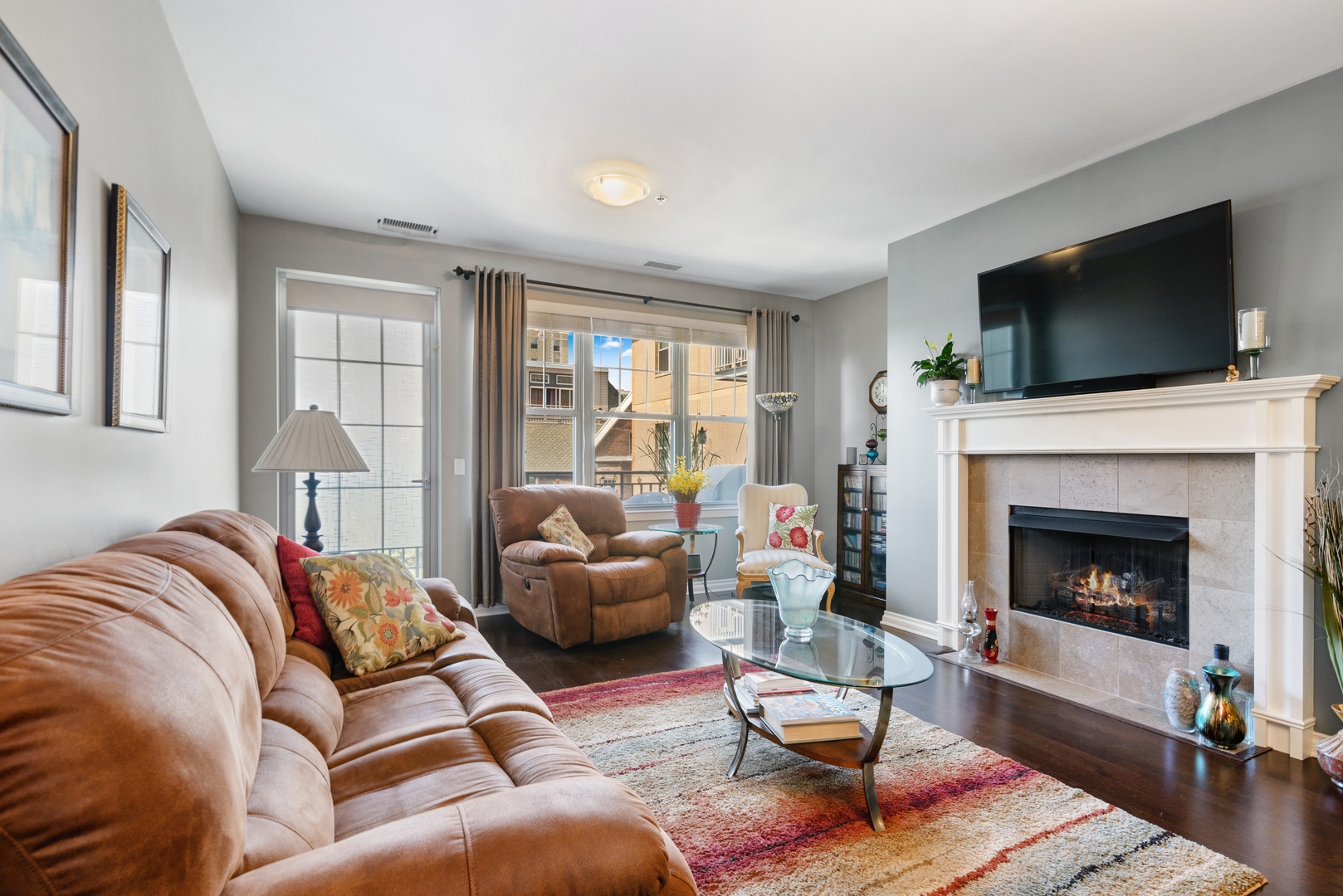 5556 North Sheridan Road, Unit 408 Chicago, IL 60640 - Photo 6 of 19 a living room with furniture a flat screen tv and a fireplace