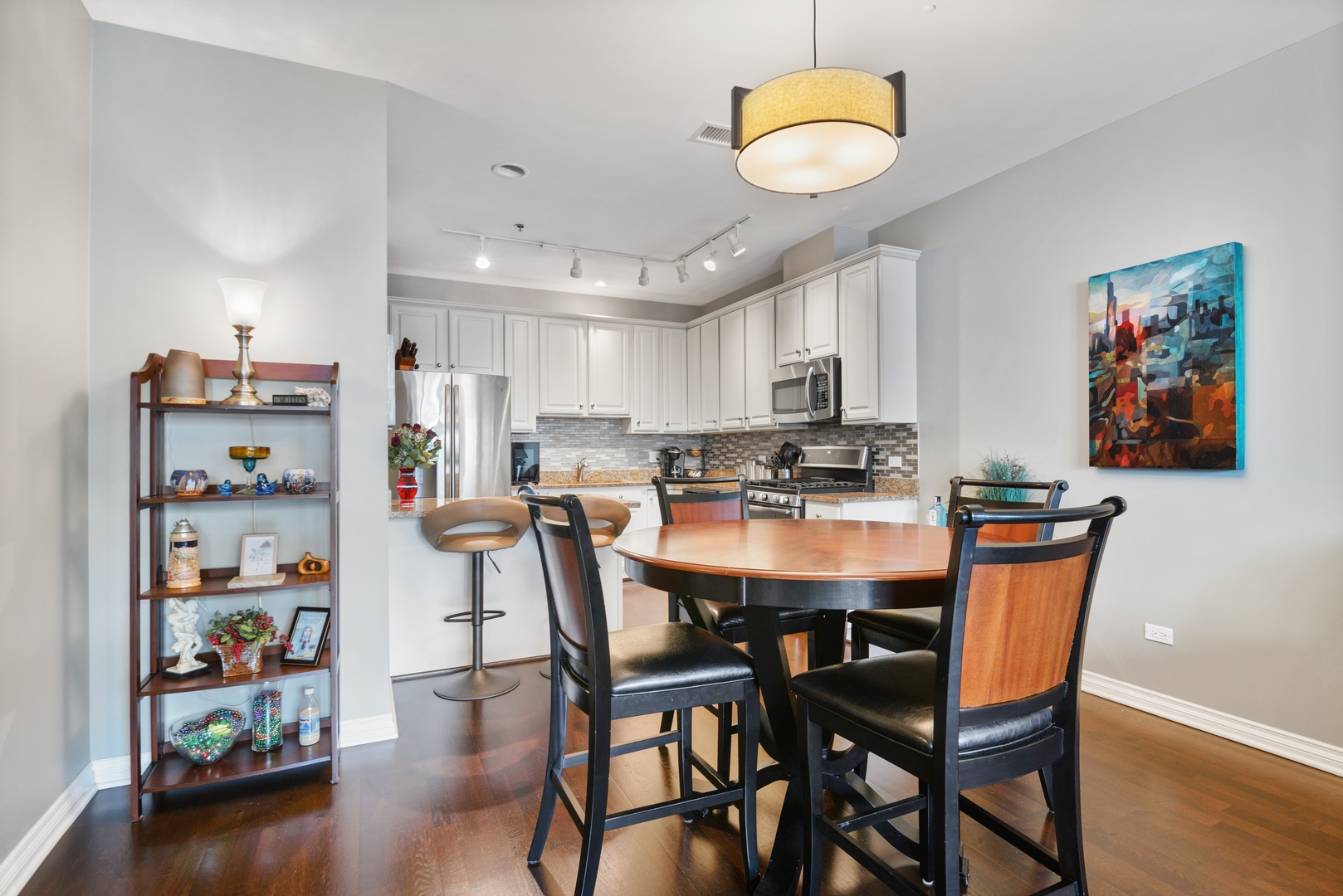 5556 North Sheridan Road, Unit 408 Chicago, IL 60640 - Photo 9 of 19 a view of a dining room with furniture and wooden floor