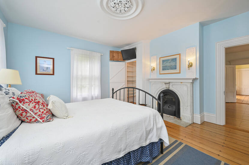 69 Doane Road Harwich Port, MA 02646 - Photo 12 of 38 a bedroom with a bed and a fireplace